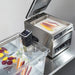 Hamilton Beach HSV1000 AcuVide 1000 immersion circulator in a clear water bath with vacuum-sealed vegetables