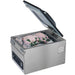 Hamilton Beach HVC305 chamber vacuum sealer with lid open and vacuum-packed chicken inside the chamber