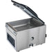 Hamilton Beach HVC406 chamber vacuum sealing machine with clear lid open showing the empty stainless chamber