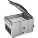 Hamilton Beach HVC406 chamber vacuum sealer with lid open and a white filler plate inside the chamber, angled