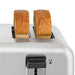 Hamilton Beach 24855 commercial 4 slot toaster, close-up of two thick toasted slices rising from the wide slots