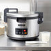 Hamilton Beach 37590 commercial 90 cup rice cooker/warmer on a stainless steel kitchen counter with rice paddle