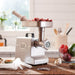 LEM 1158 size 8 Mighty Bite meat grinder shown in use on a kitchen counter grinding cubed beef into a tray