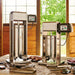 LEM 1219 Big Bite electric 20 lb sausage stuffer in use on an outdoor table with fresh sausages and tubes