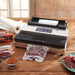 LEM 1253 MaxVac 500 out of chamber vacuum sealer on a kitchen counter with vacuum-sealed meat and bag roll