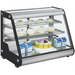Nordic Air NACP-36 angled glass refrigerated pastry display case shown stocked with cakes and drinks