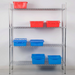 Phoenix chrome 72-inch four shelf wire shelving kit holding red and blue plastic storage bins against a grey wall