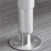 Phoenix STFL stainless steel leg anchor shown installed on a table leg and bolted to the floor