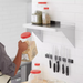 Phoenix stainless steel wall shelf shown in use in a kitchen, holding ingredient containers above a counter