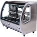 Pro-Kold DDC-60 curved glass 56 inch refrigerated deli case in stainless steel finish with glass shelves, angled view