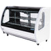 Pro-Kold DDC-80 curved glass 74 inch refrigerated deli case in white finish with interior shelves, angled front view