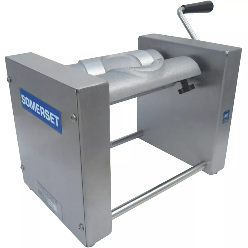 Somerset SPM-45 pastry and turnover forming machine, stainless steel frame with hand crank and roller, angled view