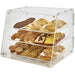 Winco ADC-3 three tier acrylic display case, clear bakery case with sliding doors filled with pastries, angled