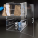Winco ADC-4 four tier clear acrylic display case, hinged door open with paper takeout bags and cups on shelves