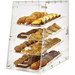 Winco ADC-4 four tier clear acrylic display case filled with muffins, cookies and pastries, angled front view