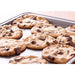 Winco aluminum 1/8 size sheet pan shown in use with freshly baked chocolate chunk cookies on the aluminum pan