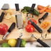 Winco apple corer shown alongside Winco soft grip graters and peelers with fresh apples and produce on a board