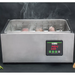 Winco ESVC-28D Spectrum thermal circulator in use, steaming water bath holding vacuum-sealed food on a dark backdrop