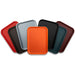 Winco plastic cafeteria trays stacked in several colours including red, grey, orange, black, brown and teal