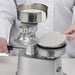 Winco KATTEX HBP-3 burger patty press in use, placing a round paper patty sheet into the stainless steel mould