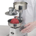 Winco KATTEX HBP-3 heavy-duty burger patty press in use, ground beef placed in the mould before pressing