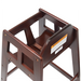 Winco mahogany finish wooden high chair, close-up of the seat, safety strap and warning label, angled side view