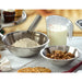 Winco stainless steel economy mixing bowls shown in use holding flour and walnuts for baking